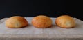 Three Burger Buns on Wood Royalty Free Stock Photo