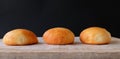 Three Burger Buns on Wood (Front View) Royalty Free Stock Photo