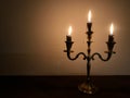 three burning candles burn down on a candlestick on Hanukkah