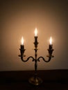three burning candles burn down on a candlestick on Hanukkah