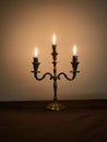 three burning candles burn down on a candlestick on Hanukkah