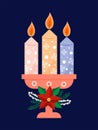 Three burning candles in a candlestick, lit in anticipation of the birth of Jesus Christ, framed by a spruce wreath with