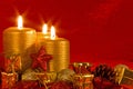 Three burning candles in a Christmas setting Royalty Free Stock Photo