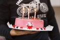 Three burning candles on the pink bithday cake