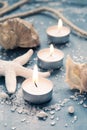 Three burning candles in a row on background of sea objects, tin Royalty Free Stock Photo