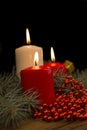 Three burning Christmas candles on the background of fir-tree br Royalty Free Stock Photo