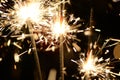 Three burning christmas sparklers. Royalty Free Stock Photo