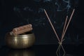 Burning incense sticks and singing bowl isolated on black background Royalty Free Stock Photo