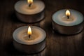 Three burning candles on the table