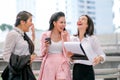 Three business Asian girls are acting as happy and exciting outside the office during day time