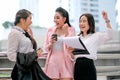Three business Asian girls are acting as happy and exciting outside the office during day time