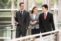 Three Business Colleagues Chatting Walking