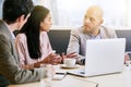 Three business executives communicating during meeting in conference room Royalty Free Stock Photo