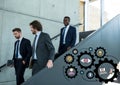 Three business men walking down stairs and black gear graphics