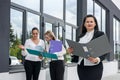 Three business partners with folders posing outside office building Royalty Free Stock Photo