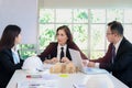 Three business people have discussing about building plan in meeting desk, engineer team work together on construction project in Royalty Free Stock Photo