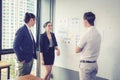 Three business people in modern office looking report and analyzing. Royalty Free Stock Photo