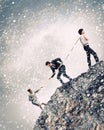 Three business people pulling rope