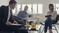 Three business people sitting around a coffee table Royalty Free Stock Photo