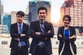 Three business people standing with arms crossed. Royalty Free Stock Photo