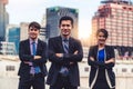 Three business people standing with arms crossed. Royalty Free Stock Photo