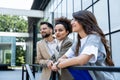 Three business people waiting in front of office building taking a break, before staff meeting. Lawyers and law students on Royalty Free Stock Photo