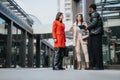 Diverse business colleagues engaging in outdoor discussion in urban setting. Royalty Free Stock Photo