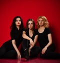 Three business woman in black dresses having fun celebrating on red Royalty Free Stock Photo