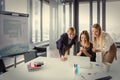 Three business women in modern office working on the project together Royalty Free Stock Photo