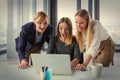 Three business women in modern office working on the project together Royalty Free Stock Photo