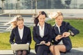 Three business women using technology