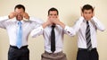 Three businessman covering eyes, mouth and ears