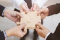 Three businessman hand hold trying to connect Jigsaw wooden puzzle piece stand floor office background. one part of whole. symbol Royalty Free Stock Photo