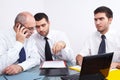 Three businessman sitting at table during meeting