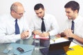 Three businessman sitting at table during meeting Royalty Free Stock Photo