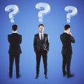 Three businessmans with question marks Royalty Free Stock Photo