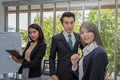 Three businessmen in the meeting room. Team of Asian business posing in meeting room at office. Working brainstorming at spacious Royalty Free Stock Photo