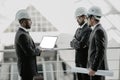 Three businessmen in ties and hardhats surprised with window scene. Property investor visiting site and impressed with neighboring