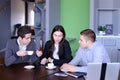 Three businessmen, woman and men discussing robot with cup of te Royalty Free Stock Photo