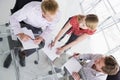 Three businesspeople in boardroom with paperwork