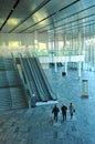 Three businesspeople in a conference center going to a business meeting