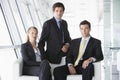 Three businesspeople sitting in office lobby