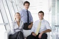 Three businesspeople sitting in office lobby