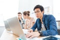 Three businesspeople working in office with laptops Royalty Free Stock Photo