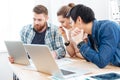 Three businesspeople working for project using laptops in office together Royalty Free Stock Photo