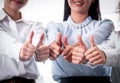 Three businesswoman partners show the gesture of thumps up