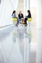 Three Businesswomen Meeting Around Table In Modern Office Royalty Free Stock Photo