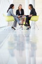 Three Businesswomen Meeting Around Table In Modern Office Royalty Free Stock Photo