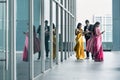 Three busy Indian business people using high-tech devices Royalty Free Stock Photo