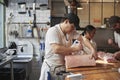 Three butchers preparing meat,cuts of meat at a butcher's shop